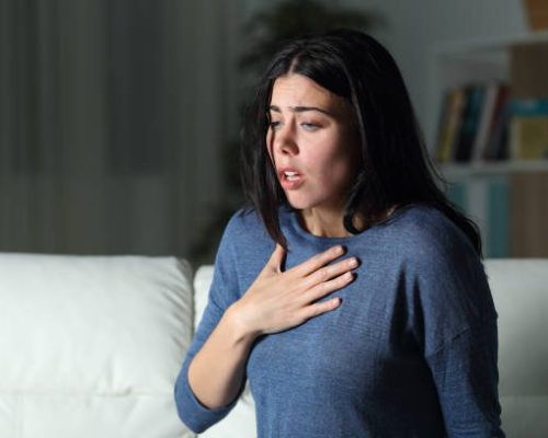 Woman suffering an anxiety attack alone in the night Woman suffering an anxiety attack alone in the night